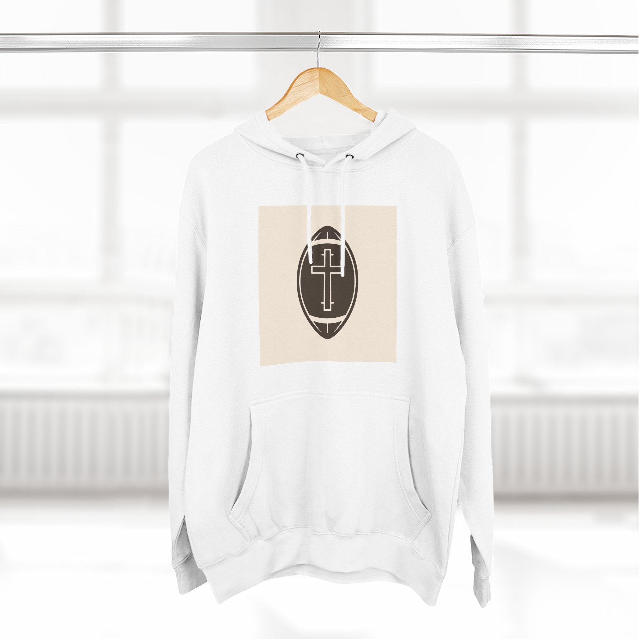 A cozy hoodie that unites faith and football with a bold cross set inside a classic football design.